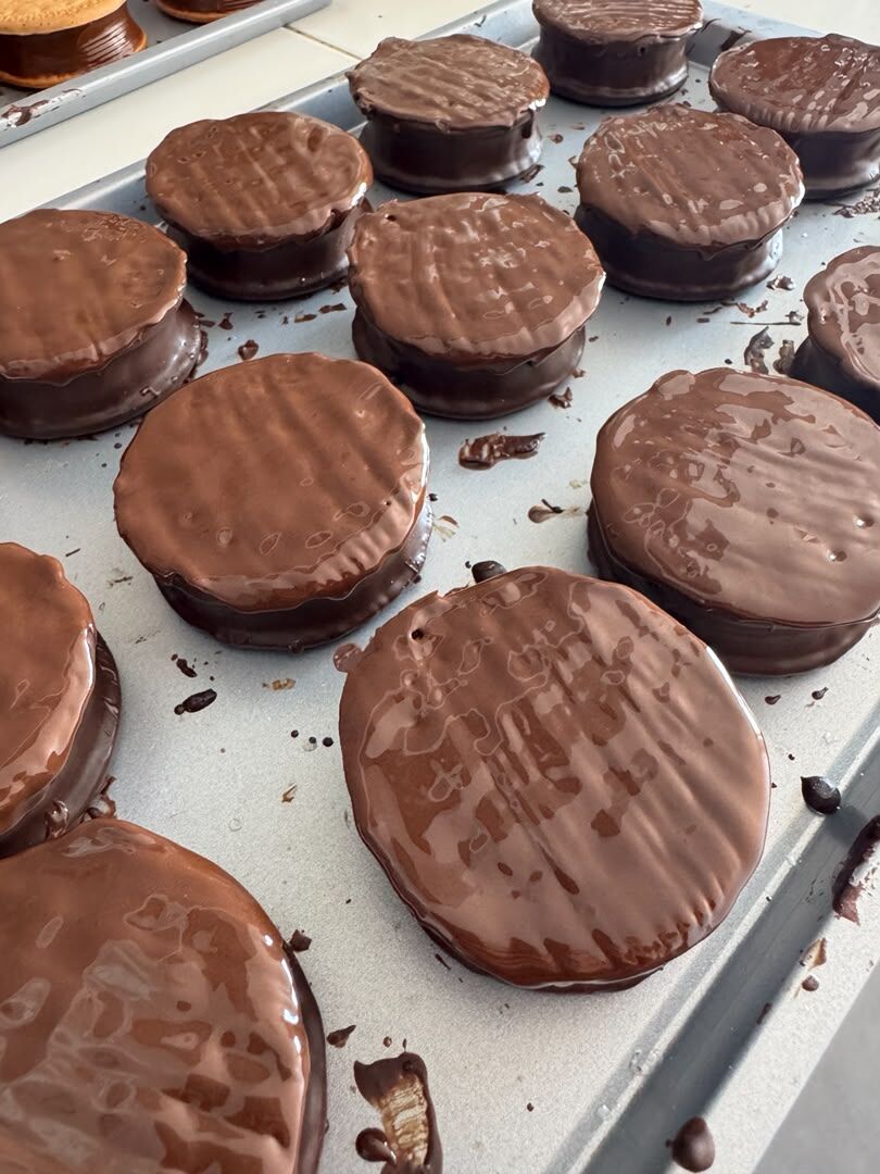 Bandeja de galletas recién bañadas en chocolate en Maracay